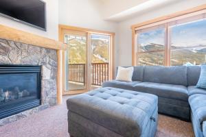 a living room with a couch and a fireplace at Copper Springs Lodge 404 in Copper Mountain +12 photos
