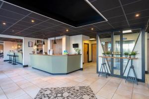 a lobby of a hospital with a reception counter at Sure Hotel by Best Western Dijon Sud in Chenôve