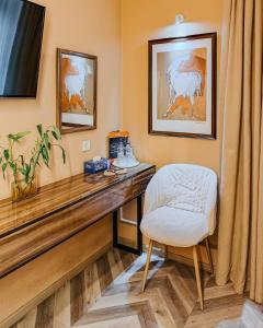 a desk with a white chair in a room at Guest house TWINS in Tashkent
