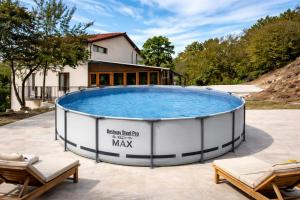a large swimming pool in front of a house at Къща за гости Трявна in Tryavna