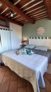 a bedroom with a large bed with a blue blanket at Maison Cistaredda in Sotta