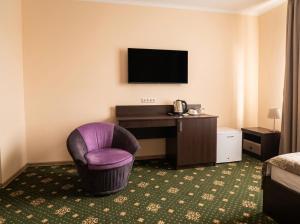 a hotel room with a desk and a chair at Oasis Hostel in Kostanay