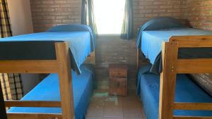 a bedroom with two bunk beds and a window at Casa de vacaciones Naty in Villa Carlos Paz