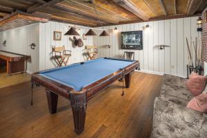 a pool table in the middle of a living room at Appalachian Mountain Lodge in Boone