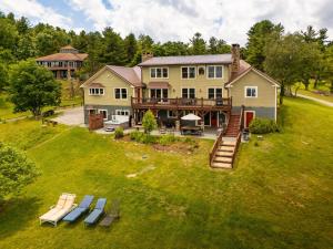 an aerial view of a large house with benches in the yard at Appalachian Mountain Lodge in Boone
