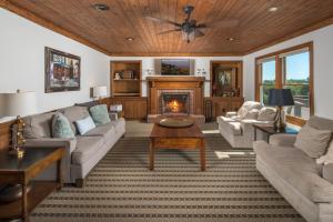 a living room with a couch and a fireplace at Appalachian Mountain Lodge in Boone +64 photos