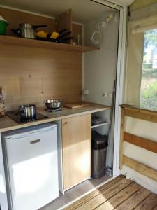 a kitchen in an rv with a stove and cabinets at TIthome in Cunlhat