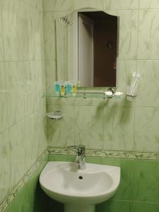a bathroom with a white sink and a mirror at Relax in the mountains - kazbegi in Arsha +17 photos