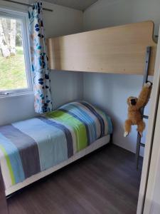 a childs bedroom with a bunk bed and a teddy bear at TIthome in Cunlhat