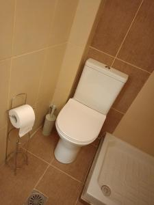 a bathroom with a toilet and a roll of toilet paper at The Eliana Serenade in Heraklio +34 photos
