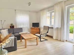 a living room with a couch and a table at Ferienwohnung Gartenblick in Amerang +16 photos