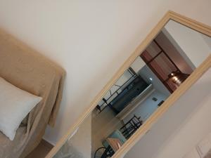an attic bedroom with a glass door leading into a room at The Eliana Serenade in Heraklio
