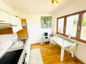 a kitchen with a table and a dining room at Relax Holidays in Rheinheim +17 photos