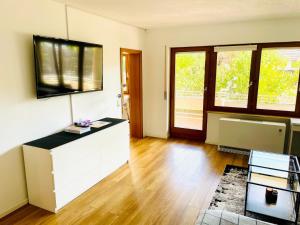 a living room with a tv on the wall at Relax Holidays in Rheinheim