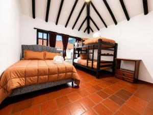 a bedroom with two beds in a room at hotel spa 360 villa de leyva in Villa de Leyva