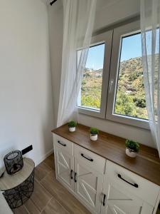 a room with a window and a dresser with plants at Apartamento Torrox Village in Torrox