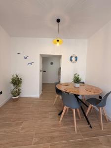 a dining room with a wooden table and chairs at Apartamento Torrox Village in Torrox