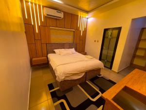 a small bedroom with a bed in a room at MOTISOFT Hotel in Yenagoa +5 photos
