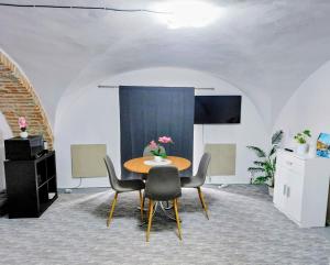 a dining room with a table and chairs at Ubytovanie Čadca in Čadca +4 photos