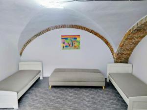 two beds in a room with an arch at Ubytovanie Čadca in Čadca