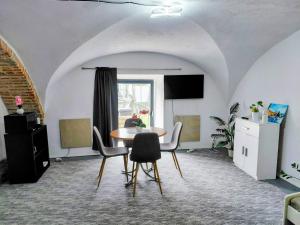 a dining room with a table and chairs at Ubytovanie Čadca in Čadca