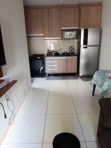 a kitchen with a large white tiled floor at Pedacinho do céu 3 in Dourados +1 photo