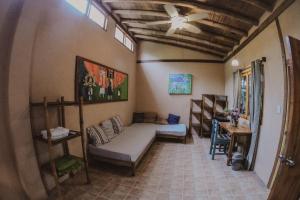 a living room with a couch and a ceiling at Hostal Rosa Mística in Montañita