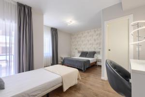 a hotel room with two beds and a window at Hotel Vivar in Griñón +83 photos