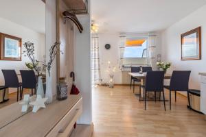 a living room and dining room with a table and chairs at Traumwohnung am Sorpesee in Sundern