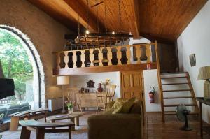 a living room with a couch and a table at Le Mas de la Vivande in Marsanne