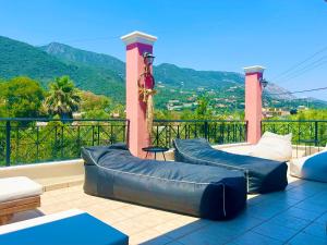 a balcony with two bean bag chairs and a view at Villa Valia Seaside in Ipsos
