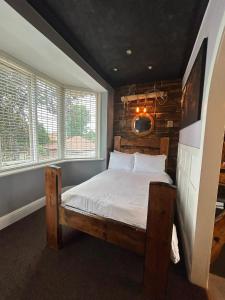 a bedroom with a bed in a room with windows at Marton Lodge in Bridlington