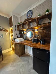 a kitchen with a counter with a sink and a mirror at Marton Lodge in Bridlington +6 photos
