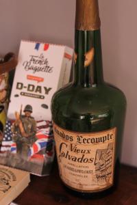 a green bottle of wine sitting on a table at Karibu Normandy in Saint-Désir
