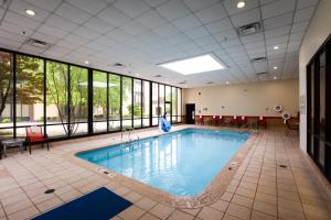 a swimming pool in a large room with windows at Wyndham Columbus in Worthington