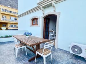 a wooden table and chairs on the patio of a house at La Casa de Papel 2 in Valle Gran Rey