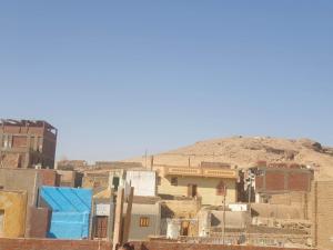 a group of buildings with a mountain in the background at Nobal best house in Aswan