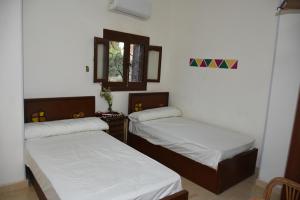 a room with two beds and a window at Nobal best house in Aswan +10 photos