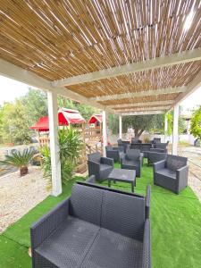 a group of chairs sitting under a pavilion at Affittacamere Vacanze a Posada in San Giovanni