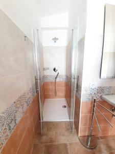 a shower stall in a bathroom with a sink at Affittacamere Vacanze a Posada in San Giovanni