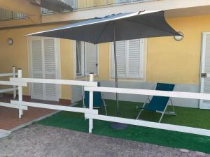 a table with an umbrella in front of a building at Oasi del Silenzio a Piea in Piea +76 photos