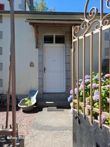 a front door of a house with a flower garden at Ty Méluzhine in Huelgoat