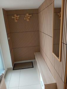 a shower with a bench in a room at apartmandomazlice in Domažlice