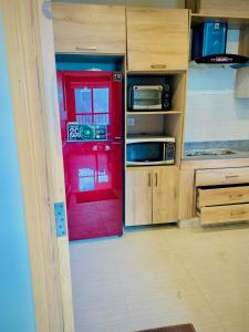a red door in a room with a kitchen at Snowra heights in Abbottabad +6 photos