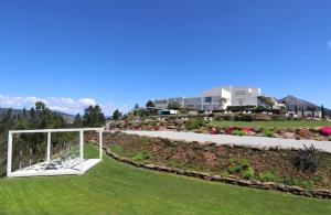 a garden with a gazebo and a building at Agua Hotels Mondim de Basto in Mondim de Basto