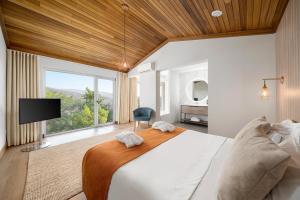 a bedroom with a large bed and a large window at Agua Hotels Mondim de Basto in Mondim de Basto +93 photos