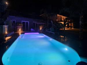 a swimming pool lit up at night at Vista Resort OPENING 13-7-26 in Albisola Superiore