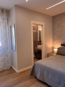 a bedroom with a bed and a bathroom at Anima Est in Naples