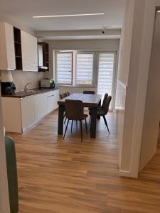 a kitchen and dining room with a table and chairs at Anima Est in Naples