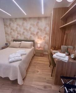 a bedroom with a large bed with towels on it at Anima Est in Naples +7 photos